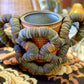 Folk Art Bottlecap Basket Over Red Can